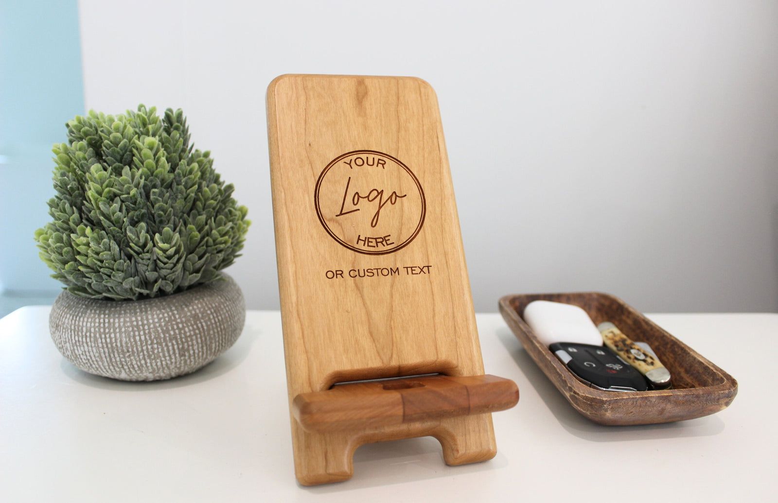 Personalized phone holder and charging station. Custom engraved to order with custom logo.